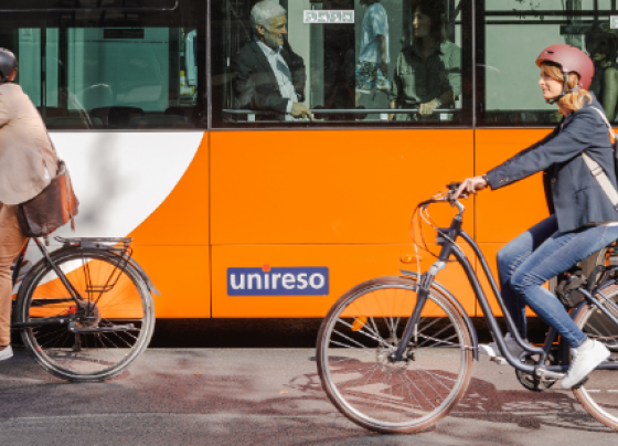 Photo of people cycling in front of a bus